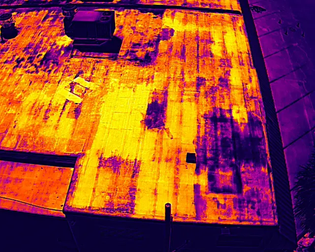 Thermal roof scan showing warm signatures consistent with trapped moisture under the membrane
